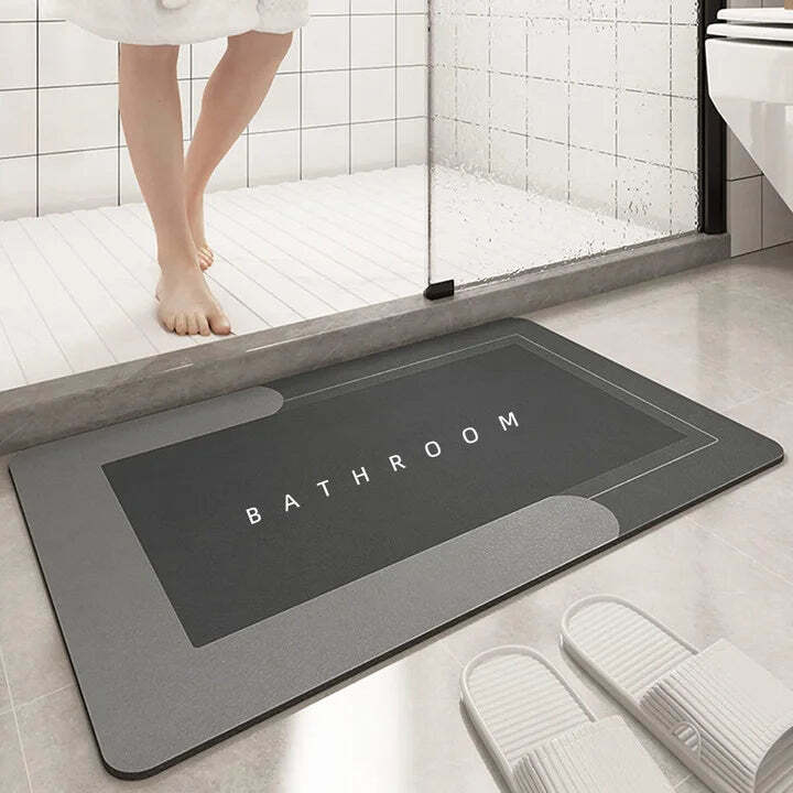 Image of Absorbent diatomite bath mat with non-slip design for comfort and safety