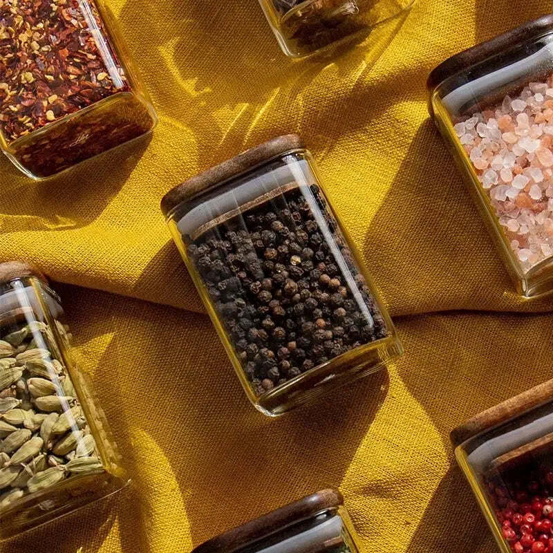 Image of Acacia wood seasoning jars with glass bottles for kitchen storage and spice organization