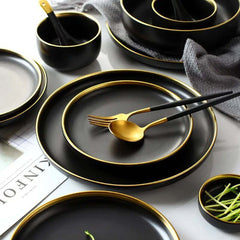 Image of Black porcelain dinnerware set with gold rim for home and restaurant