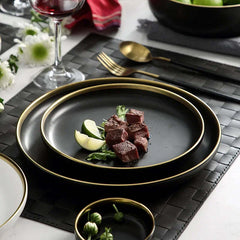 Image of Black porcelain dinnerware set with gold rim for home and restaurant