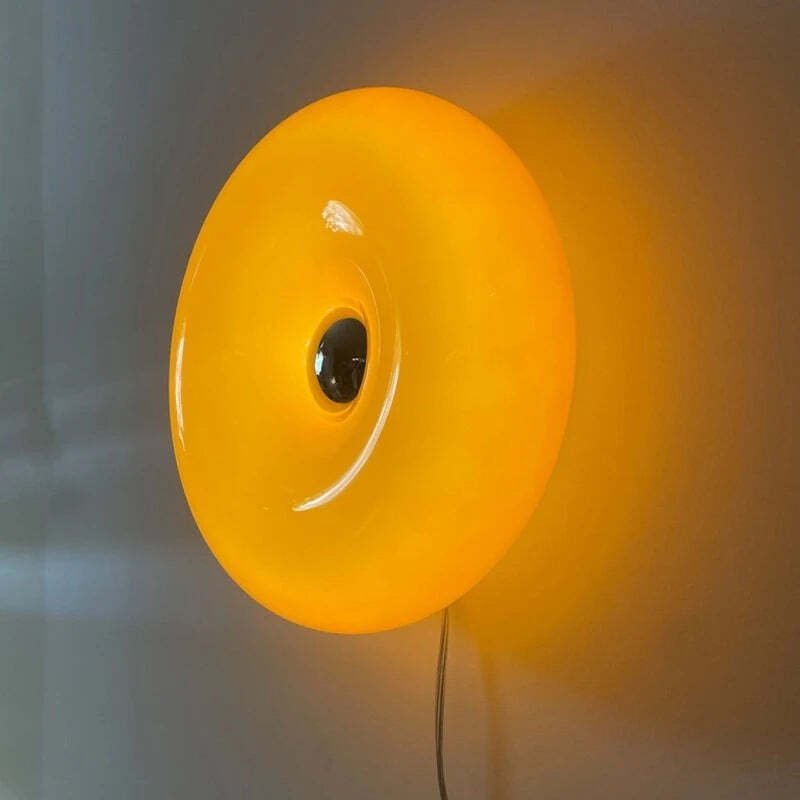 Image of Donut glass wall lamps in orange and white light for stylish indoor ambient lighting