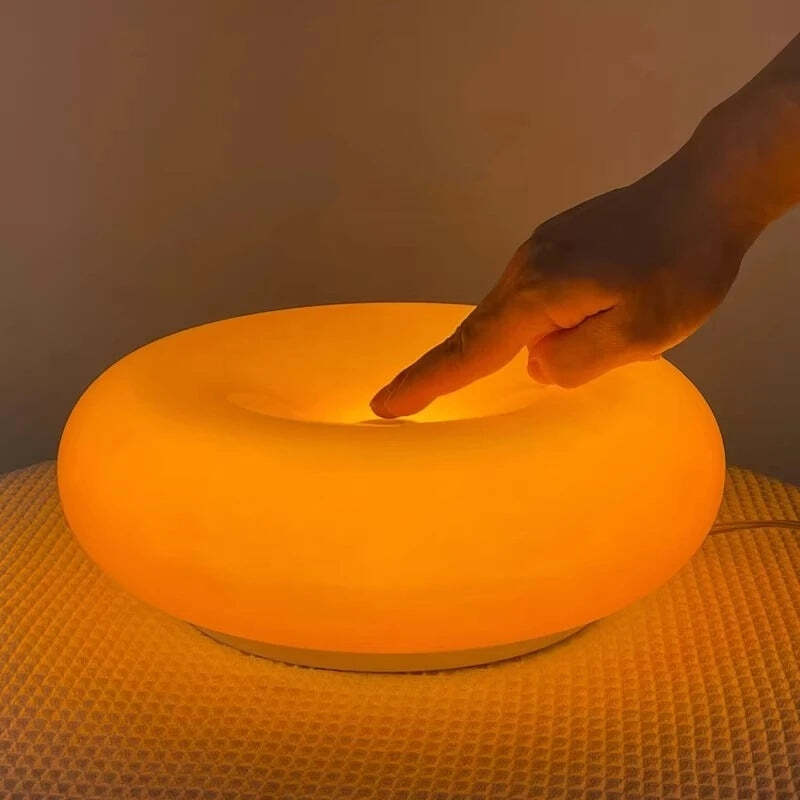 Image of Donut glass wall lamps in orange and white light for stylish indoor ambient lighting