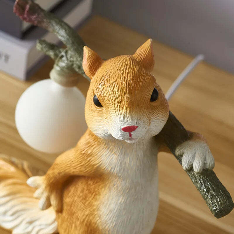 Image of Yellow squirrels desk lamp with white glass ball for children's bedroom decoration